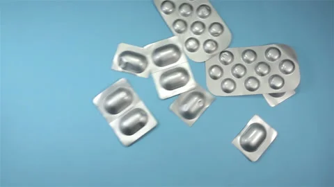 Pills in silver blisters falling in slow motion Stock Footage 153152368