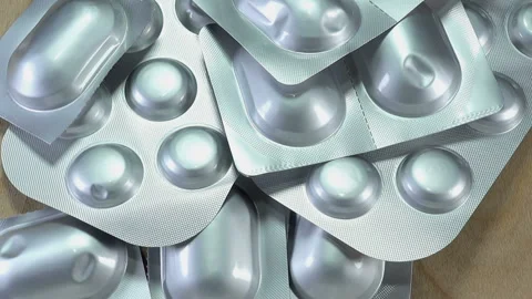 Pills in silver blisters rotate Stock Footage 143479695