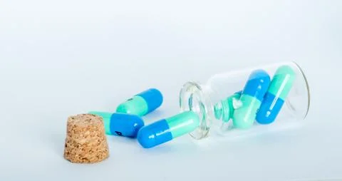 Pills in small jar Stock Photos