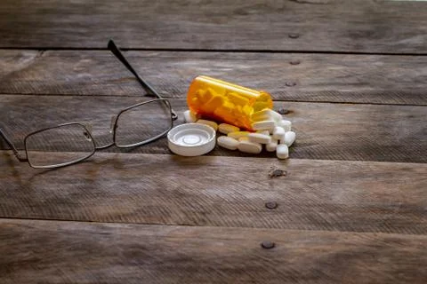 Pills spilled on kitchen table-3 Stock Photos