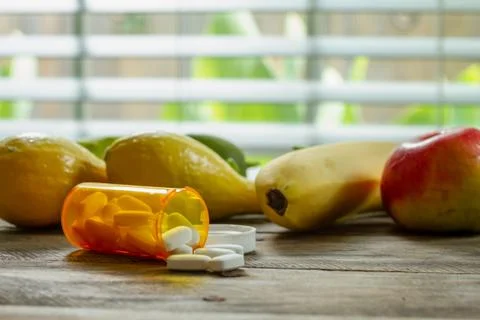 Pills spilled on kitchen table Stock Photos