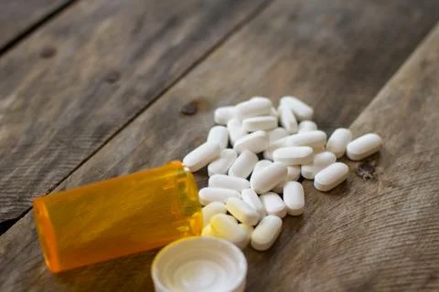 Pills spilled on kitchen table shallow DOF-2 Stock Photos