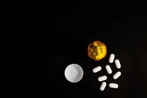 Pills spilled on table black-2 Stock Photos