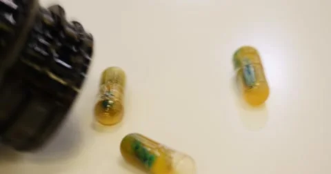 Pills spilling out of bottle Stock Footage 58286228