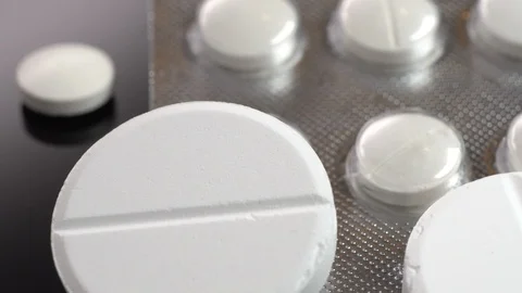 Pills spinning on black table. Close up Video stock 104264125