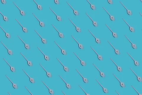 Pills in a spoon on a blue background pattern. Stock Photos