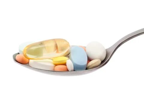 Pills on spoon with clipping path Stock Photos