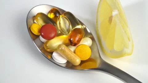 Pills with spoon with Lemon on white background Stock Footage 272149429