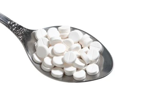 Pills in a spoon Stock Photos