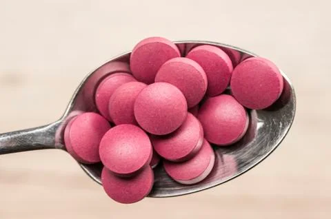 Pills in spoon Stock Photos