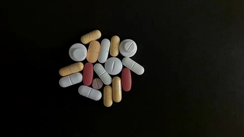 Pills, Tablets, and Capsules Isolated on Black Background Vídeos de archivo 343480397