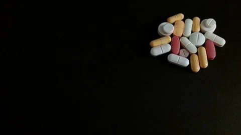 Pills, Tablets, and Capsules Isolated on Black Background Vídeos de archivo 343480418