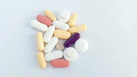 Pills, Tablets, and Capsules Isolated on White Background Vídeos de archivo 343480494