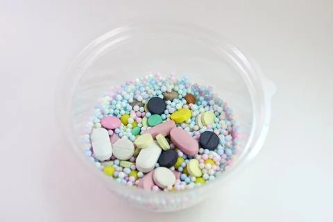 Pills, tablets and multicolored small round vitamin dragees inside plastic .. Stock Photos