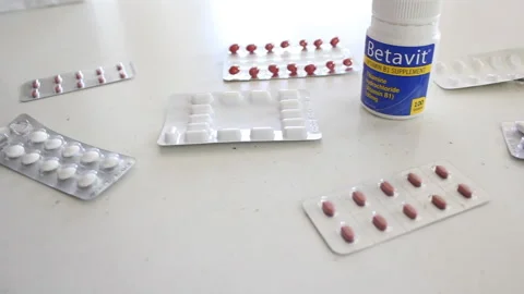 Pills tablets medication on table panning left to right 3 Stock Footage 171697530