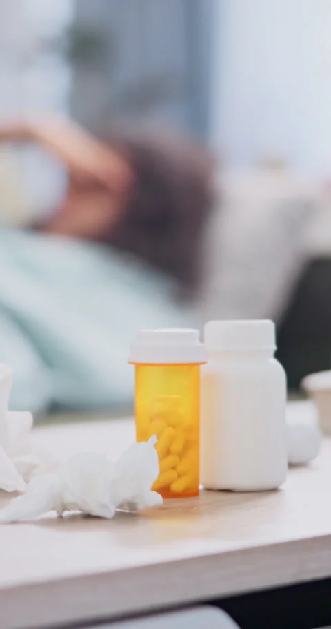 Pills, tissue and table with sick woman in home, healthcare and medication for Stock Footage 340619160