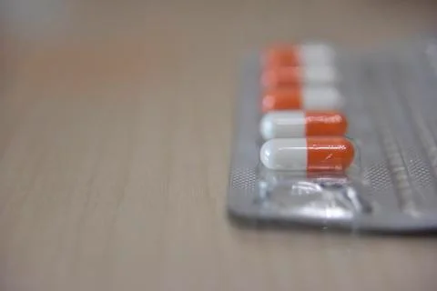 Pills in the transparent blister on the table Stock Photos
