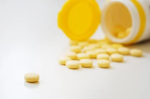 Pills on white table. Stock Photos
