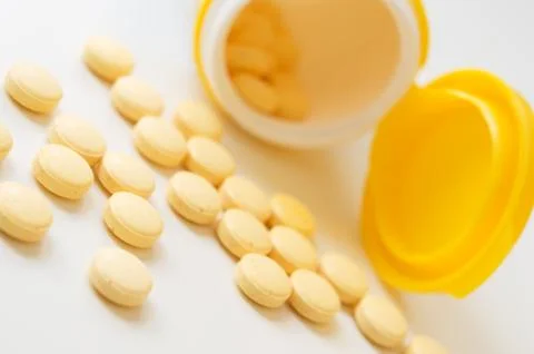 Pills on white table. Stock Photos
