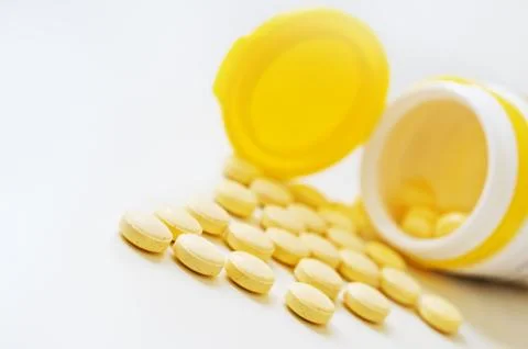 Pills on white table. Stock Photos