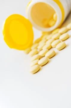 Pills on white table. Stock Photos