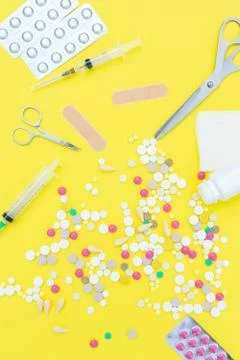 Pills on a yellow background Stock Photos