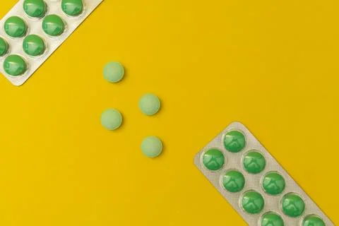 Pills on a yellow background Stock Photos