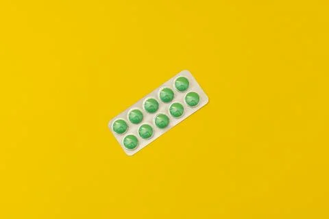 Pills on a yellow background Stock Photos