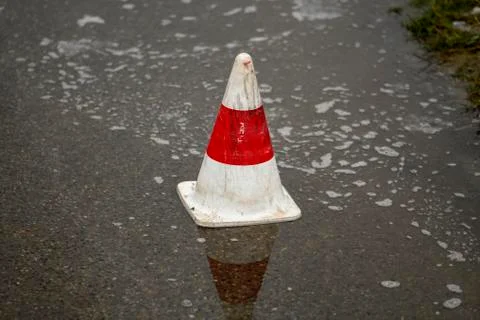 Pilone on the road in a puddle of rain Stock Photos