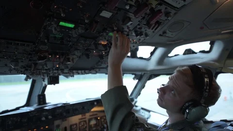 Pilot adjusting cockpit controls in E-3 Sentry Video stock 97818935