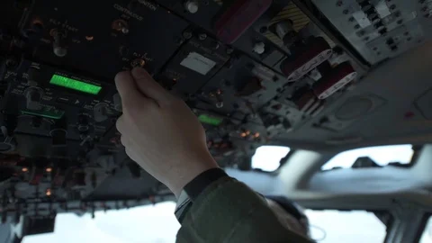 Pilot adjusting cockpit controls in E-3 Sentry Video stock 97818944