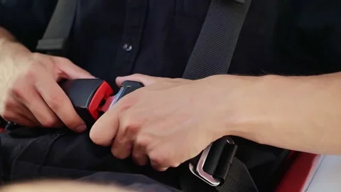 Pilot of the airplane puts on his seat belt.Man sitting in the plane closes his Stock Footage 208628664