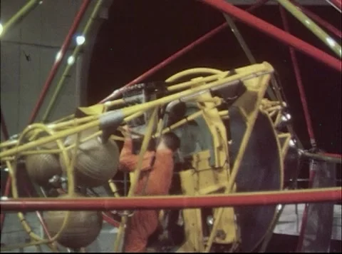 Pilot ascends steps to test chair inside cage of Multi-Axis Space Test Facility Stock Footage 262445232