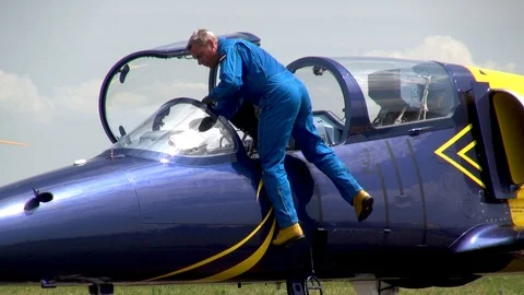 Pilot of Baltic Bees aerobatic team gets out of cockpit of L-39 aircraft. Stock Footage 121247140