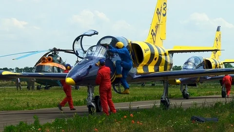 Pilot in blue overalls gets out of cockpit of L-39 training aircraft. Stock Footage 106607640