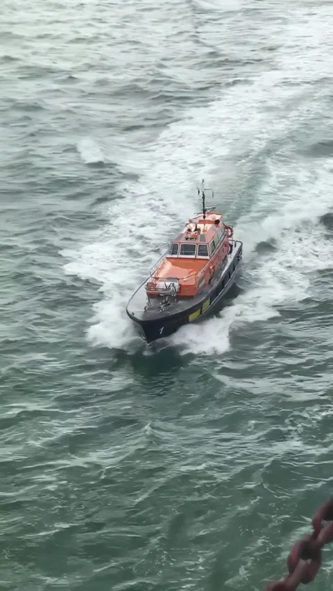 Pilot boat approaching ship in north europe Stock Footage 128640414