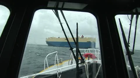 Pilot boat navigating towards cargo ship on the Columbia River, Oregon USA Stock Footage 22411016