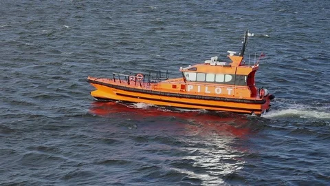 Pilot boat sails along tranquil sea in harbor on sunny day Stock Footage 121117391