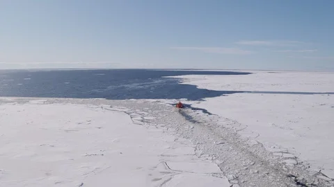 Pilot boat sails among the ice towards the open waters Stock Footage