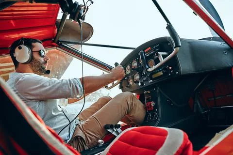 Pilot in the cabin during the flight Stock Photos