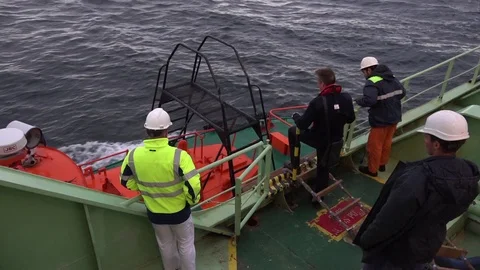 Pilot changes green tanker onyx to small pilot-motorboat Stock Footage 118357031