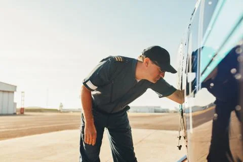 Pilot checking the engine condition of helicopter Stock Photos