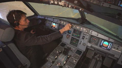The pilot checks the plane before takeoff. The pilot adjusts the autopilot. 4k Stock Footage 97997316