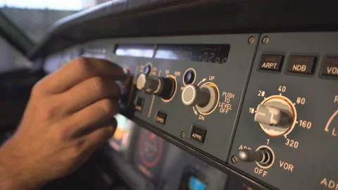 The pilot checks the plane before takeoff. The pilot adjusts the autopilot. 4k Stock Footage 97998239