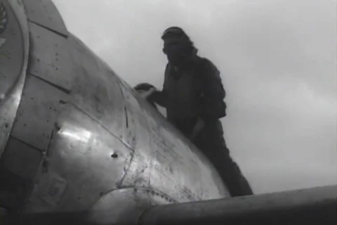 Pilot climbs into plane and plane taxies on airfield - 1944 Stock Footage 112178976