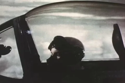 Pilot in cockpit of fighter plane and B-29 aircraft flying at height - 1945 Stock Footage 100285926