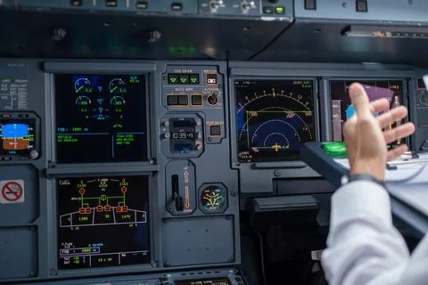 Pilot in command setting control panel in cockpit Stock Photos