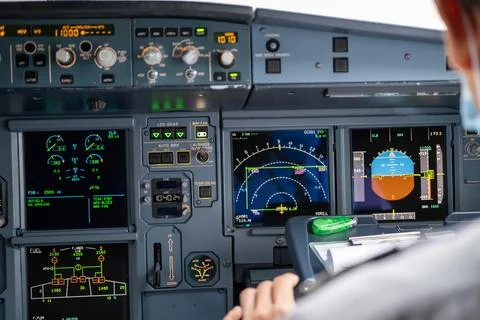 Pilot in command setting control panel in cockpit Stock Photos