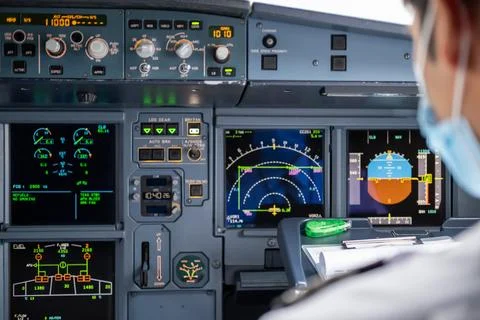 Pilot in command setting control panel in cockpit Stock Photos