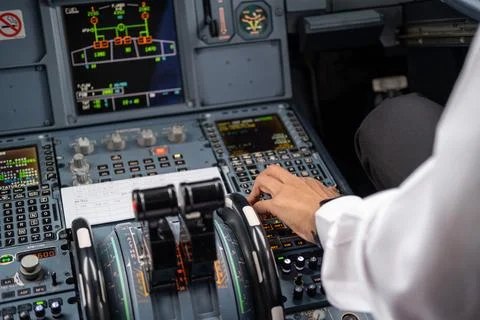 Pilot in command setting control panel in cockpit Stock Photos